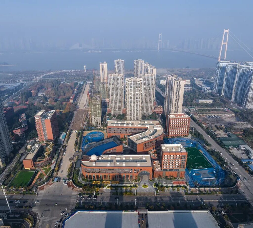 Close-up view of terracotta tiles forming a modern facade at BASIS Wuhan International School.