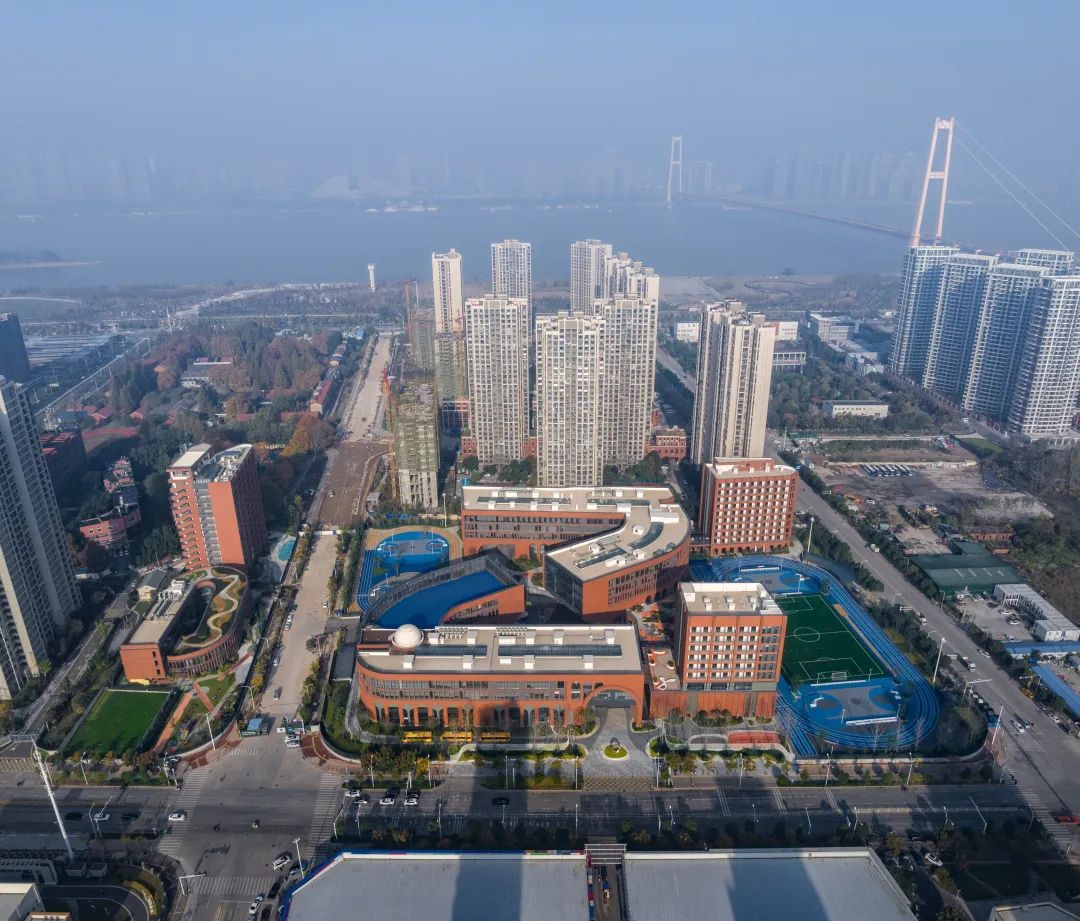 Close-up view of terracotta tiles forming a modern facade at BASIS Wuhan International School.