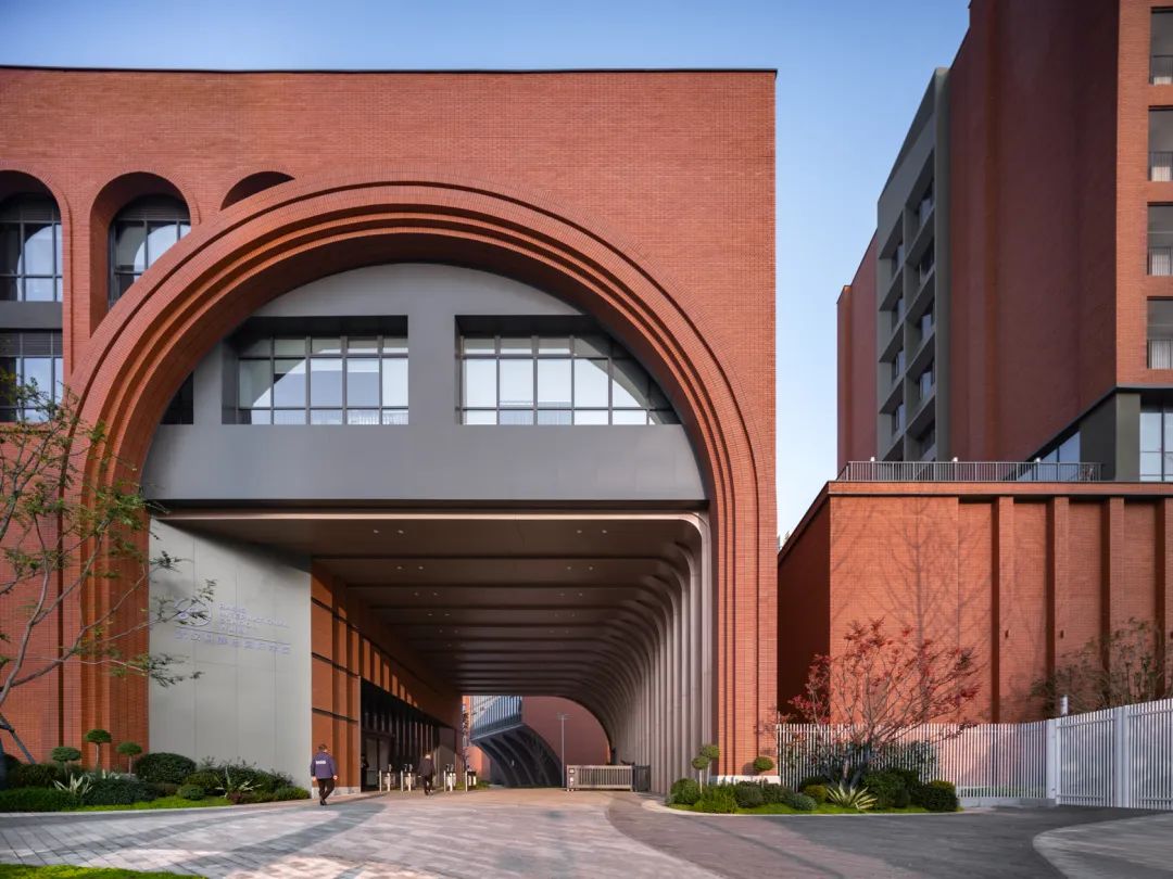 Classic terracotta brick wall showcasing timeless beauty at BASIS Wuhan educational building.