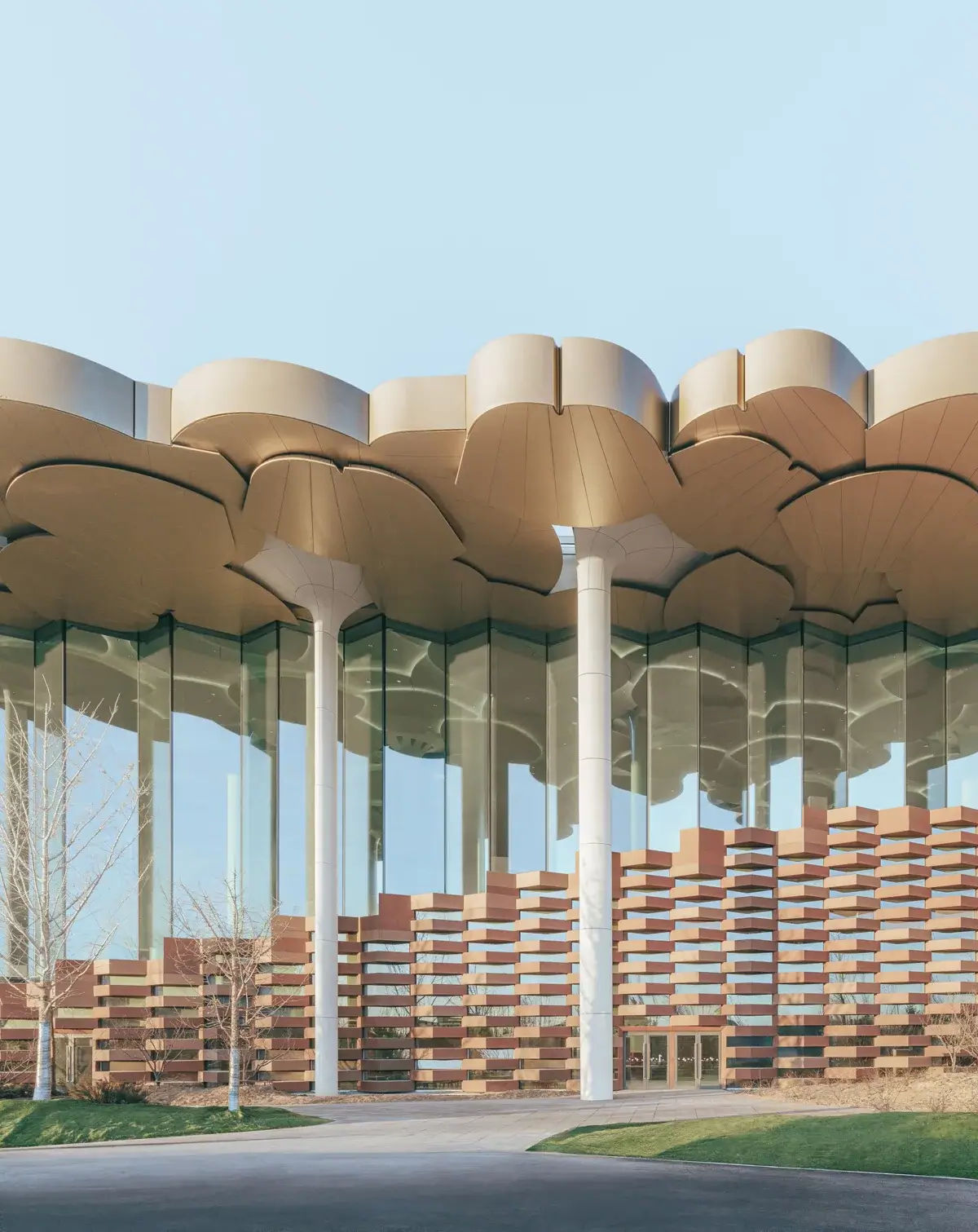 A wide-angle view of the Beijing City Library, showcasing the blend of modern glass curtain walls and LOPO's terracotta panels on the exterior facade, symbolizing the fusion of modernity and tradition.