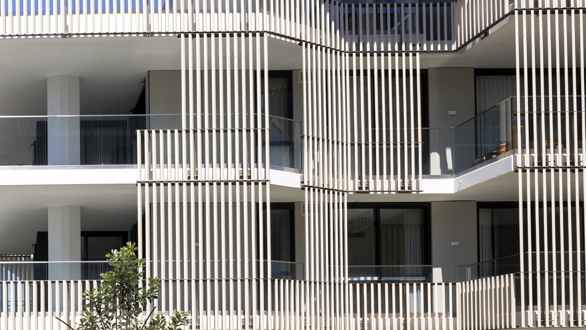 A detailed view of the LOPO Terracotta Baguettes installed on the building facade. The image highlights the precision alignment and natural texture of the terracotta elements, emphasizing their aesthetic appeal and functional role in shading and ventilation.