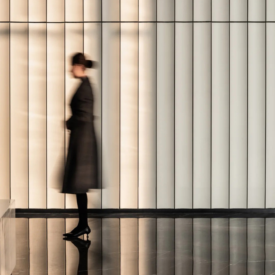 Professional office lady near terracotta panel in Vanke Metropolis lobby